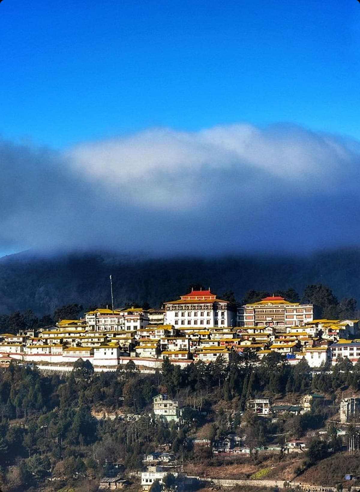 Tawang town under low clouds seen from the ridge